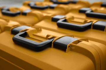 Yellow packing plastic boxes cases for geodetic total stations. Geodetic instrument boxes lined up. Shallow depth of field