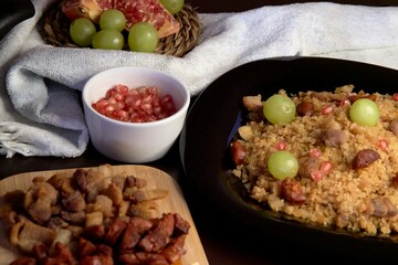 Food spanish crumbs with sausages, bacon, pomegranate and grapes