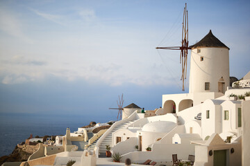 Oia island architecture and traditional white houses and windmills in Santorini, Greece
