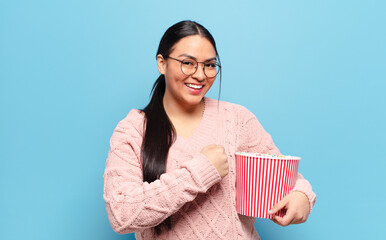 hispanic woman feeling happy, positive and successful, motivated when facing a challenge or celebrating good results