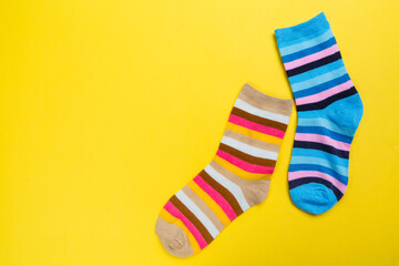 View from above. Socks are scattered on a yellow background. Clothing in the form of socks.