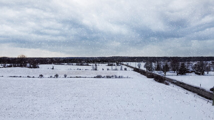 Aerial view of a corn field covered by snow, snow falling, dark mood, snow storm, near Huntmar Drive in Kanata, ottawa. Ottawa, Ontario, Canada