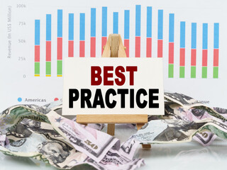 Among financial charts and money is a sign with the text - BEST PRACTICE