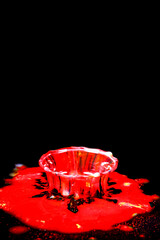 Drops of water colliding with powdered dye to create a multi coloured abstract droplet collision