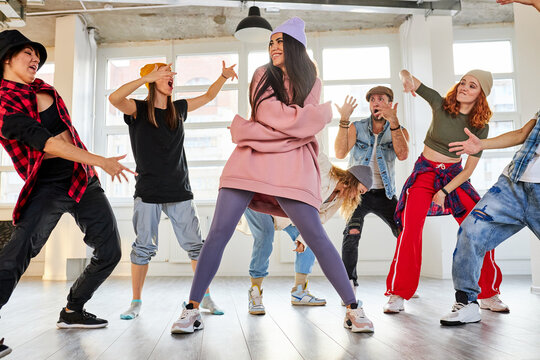 dancers having a rehearsal together, performing street dance or hip-hop movements. rnb