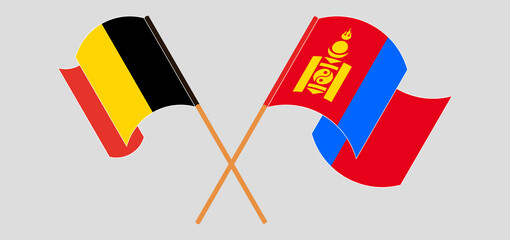 Crossed and waving flags of Belgium and Mongolia