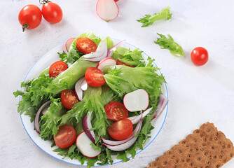Vegetable salad with cherry tomatoes, onions, radishes and fresh arugula, Healthy natural breakfast for a dietary lifestyle, detox diet Balanced food without cholesterol and GMO, selective focus,