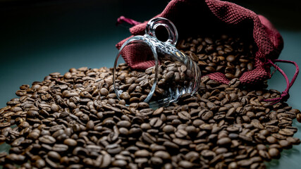 
a cup of coffee among roasted coffee beans