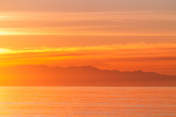 The orange glow of sunset from Deception Pass on Whidbey Island