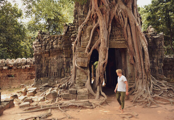 young man discovering the temples of Angkor Wat, Cambodia