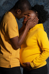 Happy African Americans are expecting a baby