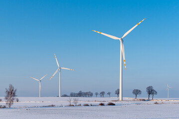 Windmills for electric power production. Winter landscape in northern Poland. Europe
