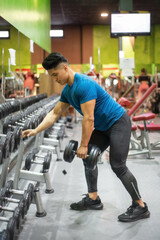 Man Exercising with Arm Weights in Gym. High quality photo