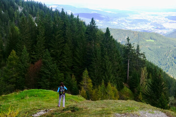 Fototapeta na wymiar female hiker with backpack while hiking in the mountains