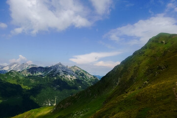 Fototapeta na wymiar high seep green hills in the mountains while hiking