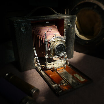 Vintage bellows camera in a spot of sunlight