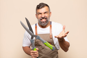 adult man looking angry, annoyed and frustrated screaming wtf or what’s wrong with you