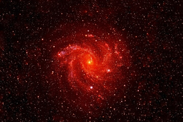 Small red galaxy on a dark background. Elements of this image were furnished by NASA.