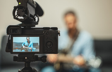 Man with semi-acoustic guitar in front of the video camera.