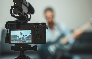 Man with semi-acoustic guitar in front of the video camera.