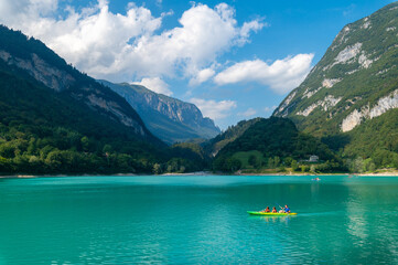Cavedine Lake. Panorama of the turquoise waters, with the alpine mountains in the distance rich in vegetation. Lake Cavedine is a small alpine lake in the Dolomites of Trentino, Trento, Italy.