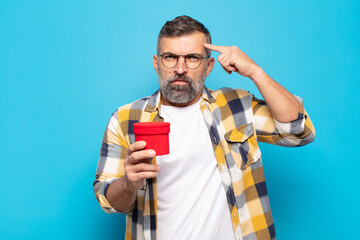 adult man feeling confused and puzzled, showing you are insane, crazy or out of your mind