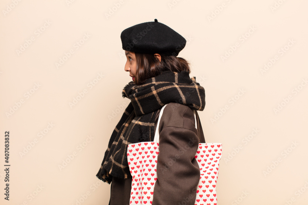 Canvas Prints hispanic woman on profile view looking to copy space ahead, thinking, imagining or daydreaming