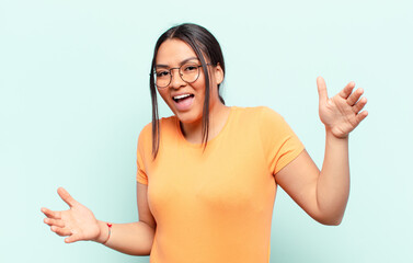 latin woman looking happy, arrogant, proud and self satisfied, feeling like a number one