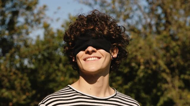 doing zorro with the mask - smiling man wears mask on his eyes