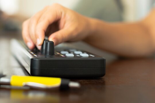 Artist composing music and and editing photos on midi controller at home office. Work at home.