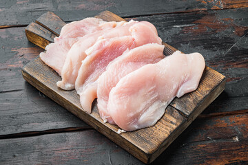 Raw chicken cutlet breast fillets, on old dark  wooden table background