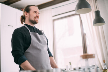 A male cook is cooking at home in the kitchen.