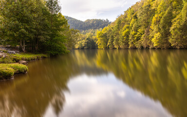 Fototapeta na wymiar A calm reflective river in the Appalachian Mountains.