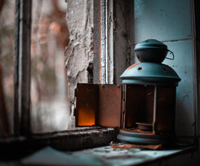 Old rusty lantern on an old window