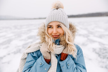 Closeup portrait of a young blonde woman on cold winter day.
