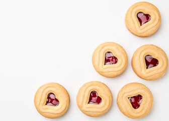 Cookies. Cookie Hearts shape Red jam or strawberry jelly inside biscuit cookie. Homemade baking. Sweet bakery. Top view on white background with copy space.