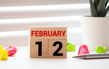 Vintage photo, February 12th. Date of 12 February on wooden cube calendar, copy space for text on...