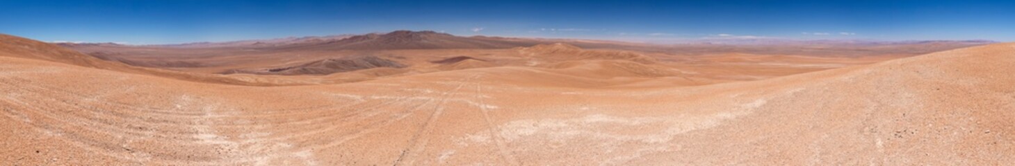 Naklejka premium Atacama Desert arid landscape view. Dry mountains with sandstone and no life around us just rocks and sand. A lonely feeling on this amazing and wild scenery at a remote place