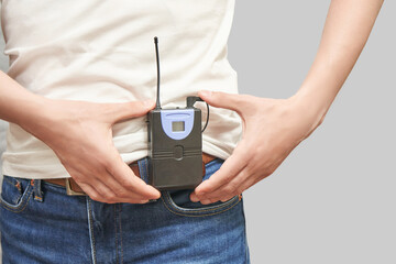 Men in translation center. Set for telemarketing. Male manager customer. Listening operator. Studio portrait. Person multi language translator. Grey background. Hand hold multy guide. Casual t-shirt