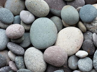Fototapeta na wymiar round pebbles river texture Boulders backdrop. Ideal concept image