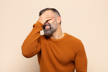 adult handsome man laughing and slapping forehead like saying d’oh! I forgot or that was a stupid...