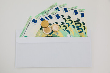 euro in a white envelope. Money in envelope. Salary in envelope. Work and pay black