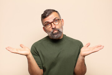 adult handsome man feeling puzzled and confused, unsure about the correct answer or decision,...