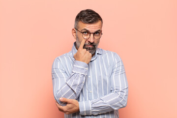 adult handsome man keeping an eye on you, not trusting, watching and staying alert and vigilant