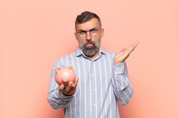 adult handsome man looking shocked and astonished, with jaw dropped in surprise when realizing...