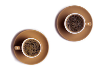 Two cups of coffee on a white table.