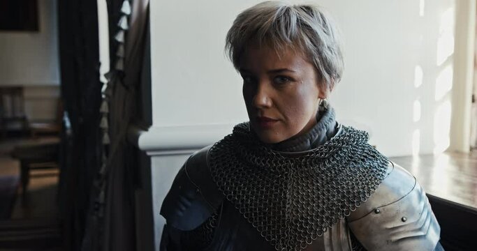 Porter is a female warrior who sits by a window in stingy armor and stares boldly into the camera. A violent female feminist as a Knight of the Middle Ages fighting women's rights.