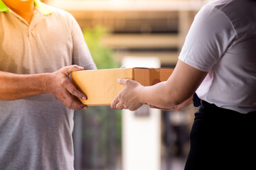 Delivery man by sending box of parcel to customers service at home