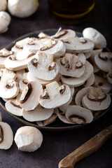 Fresh sliced white mushrooms on kitchen table 