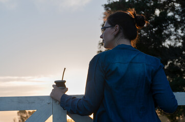Girl drinking mate in the field